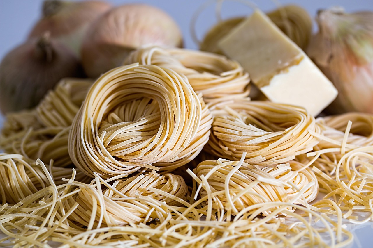 Fresh pasta being rolled with a stand mixer pasta roller attachment