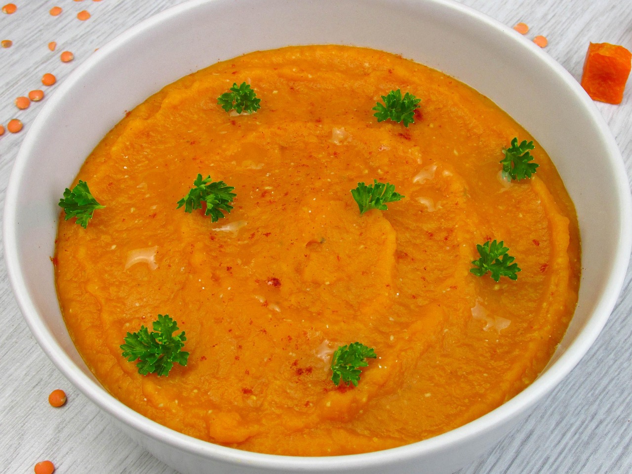 Immersion blender pureeing soup in pot