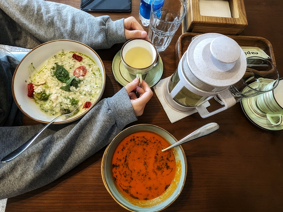 Immersion blender pureeing soup in pot