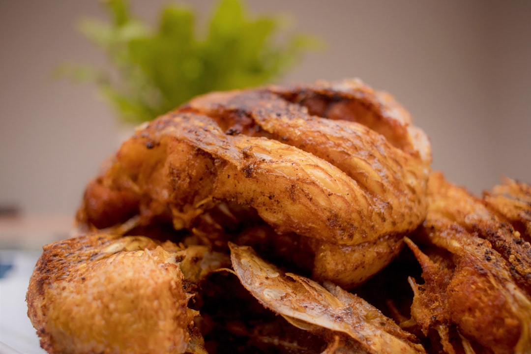 Air fryer with crispy chicken wings and vegetables