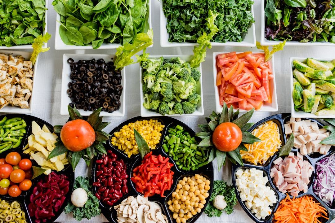 Glass meal prep containers filled with colorful prepared meals arranged in refrigerator