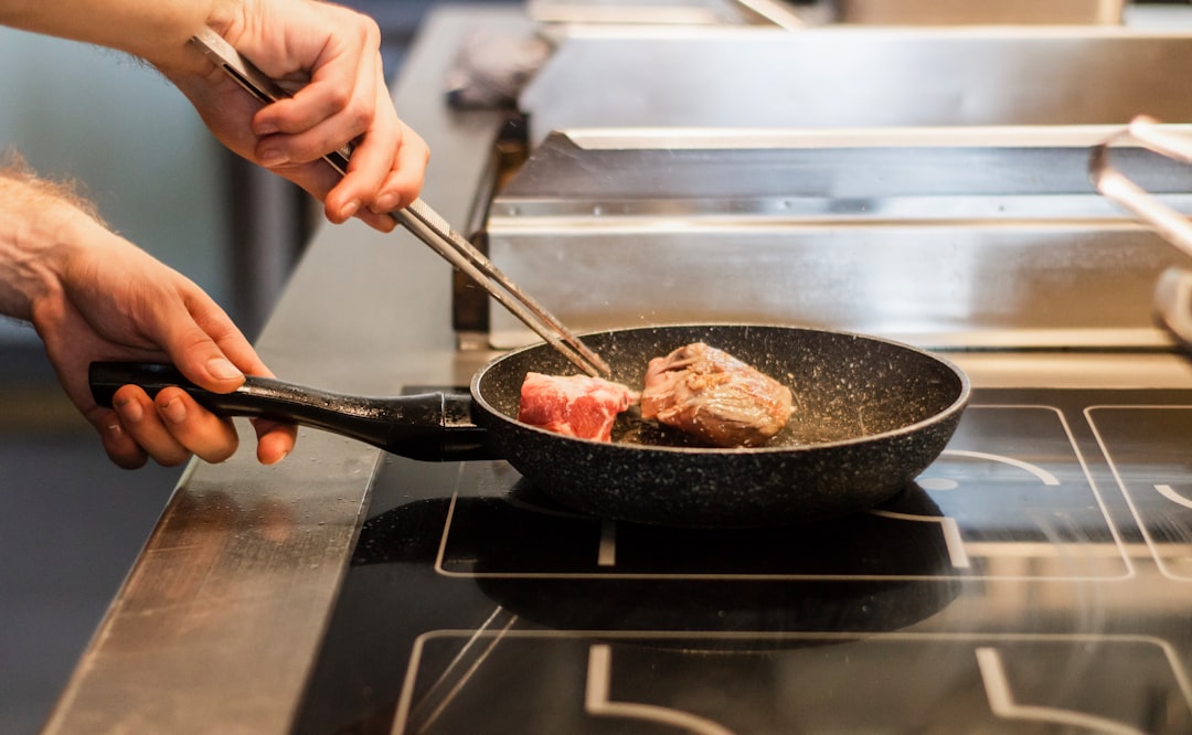 polished stainless steel frying pan in professional kitchen
