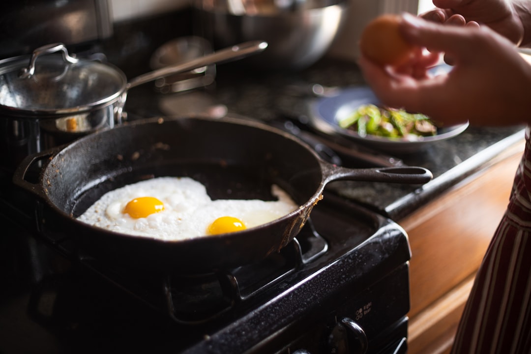 Chef cooking with non-stick pan eggs breakfast