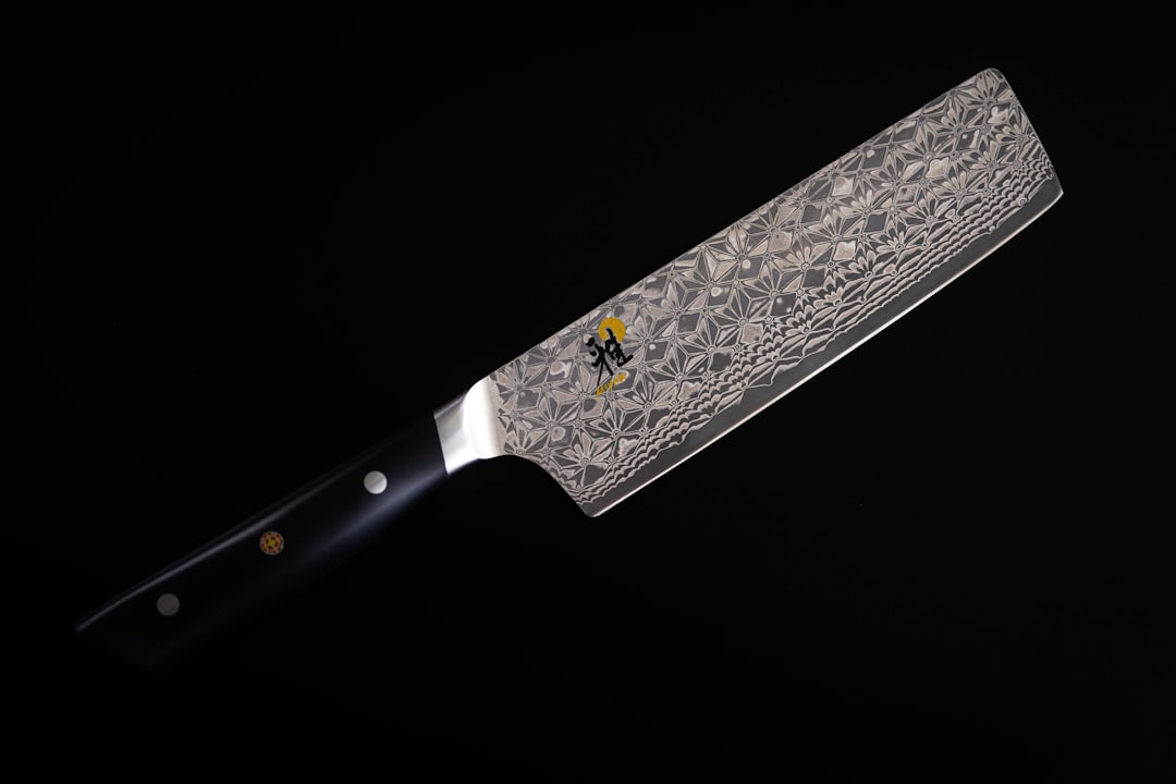 Nakiri vegetable knife with fresh sliced cucumbers and herbs