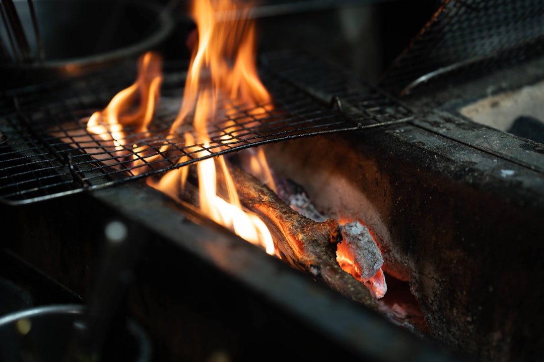 Backyard grill with flames cooking burgers
