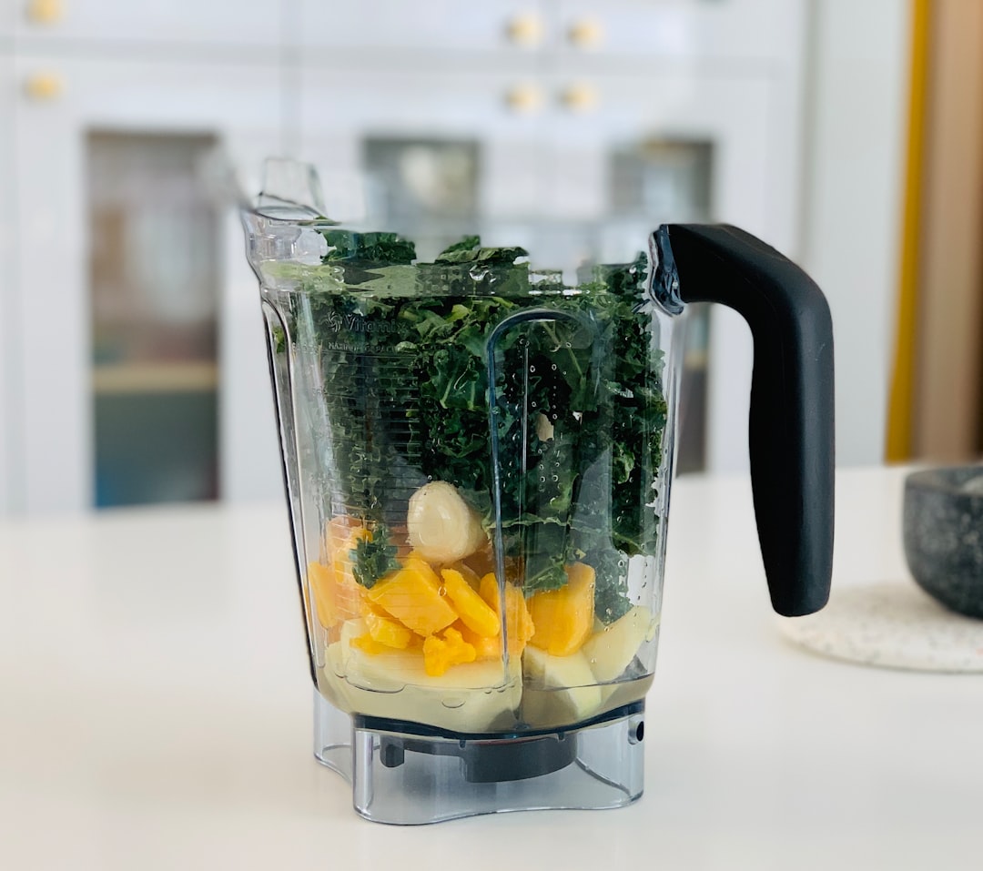 blender making smoothie with frozen fruit