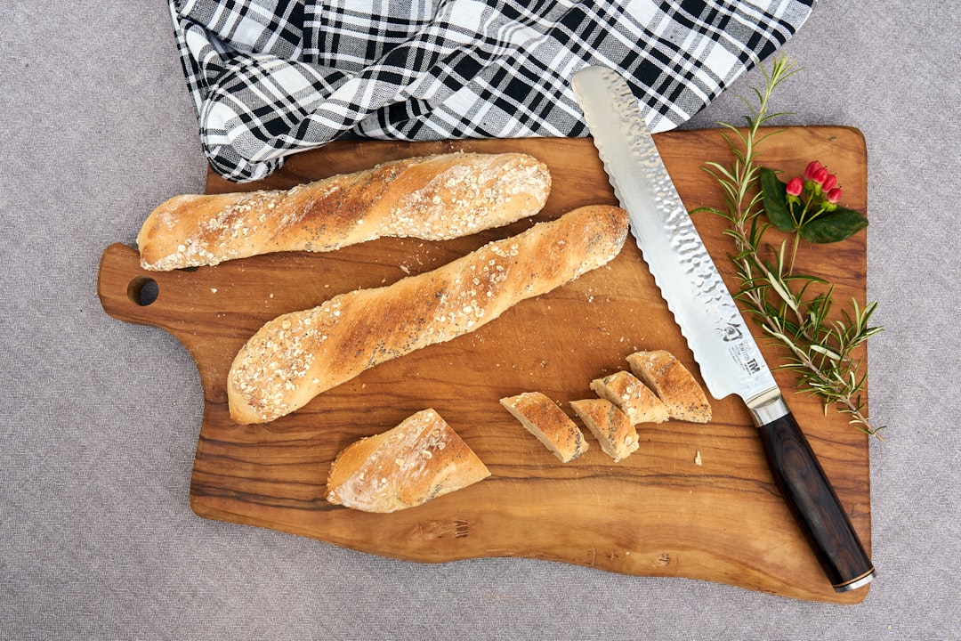 Serrated bread knife slicing artisan sourdough loaf