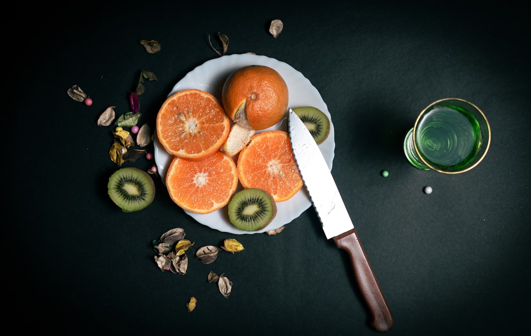 Paring knife with fresh strawberries on kitchen counter
