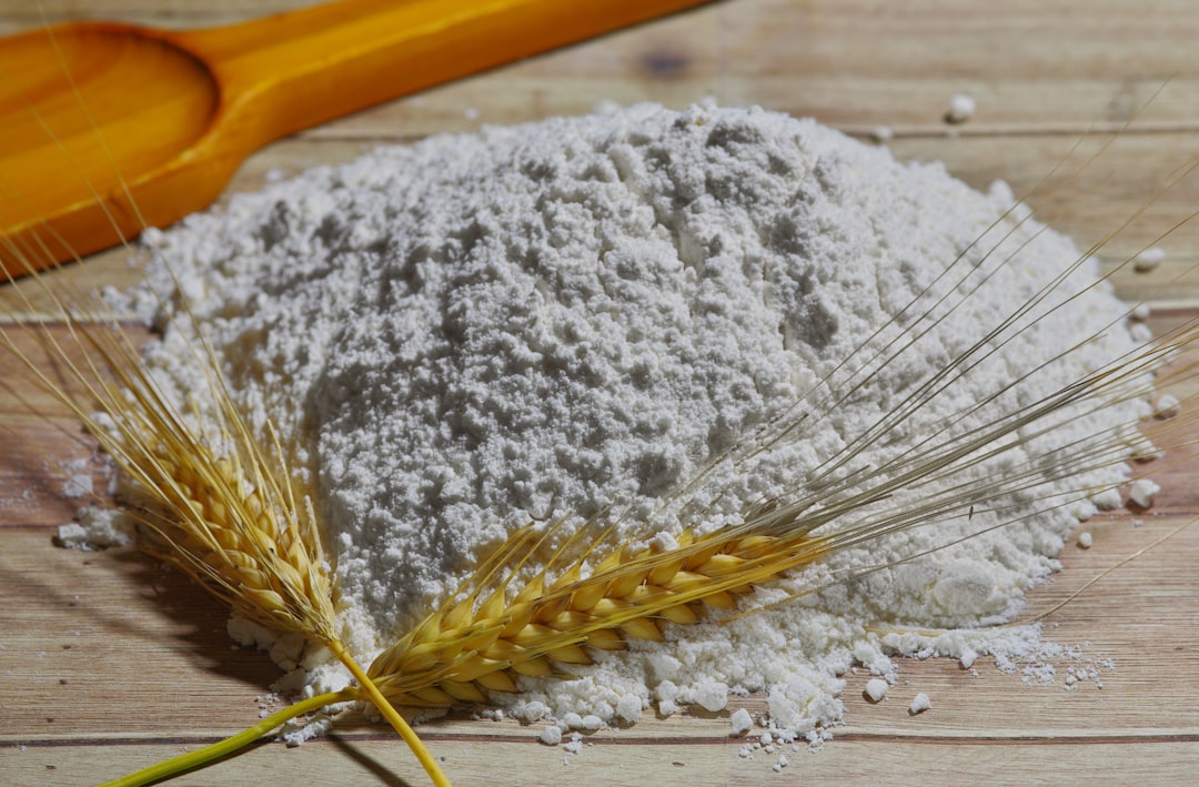 Fine mesh strainer sifting flour over bowl