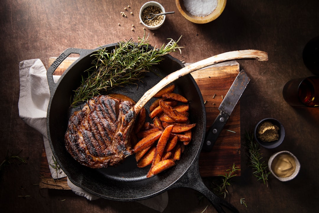 steak searing in cast iron skillet with golden crust