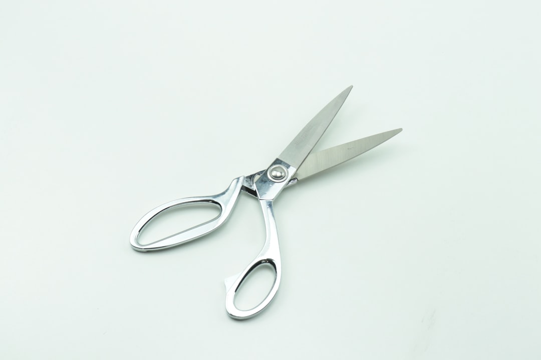 Kitchen shears cutting fresh herbs over a bowl