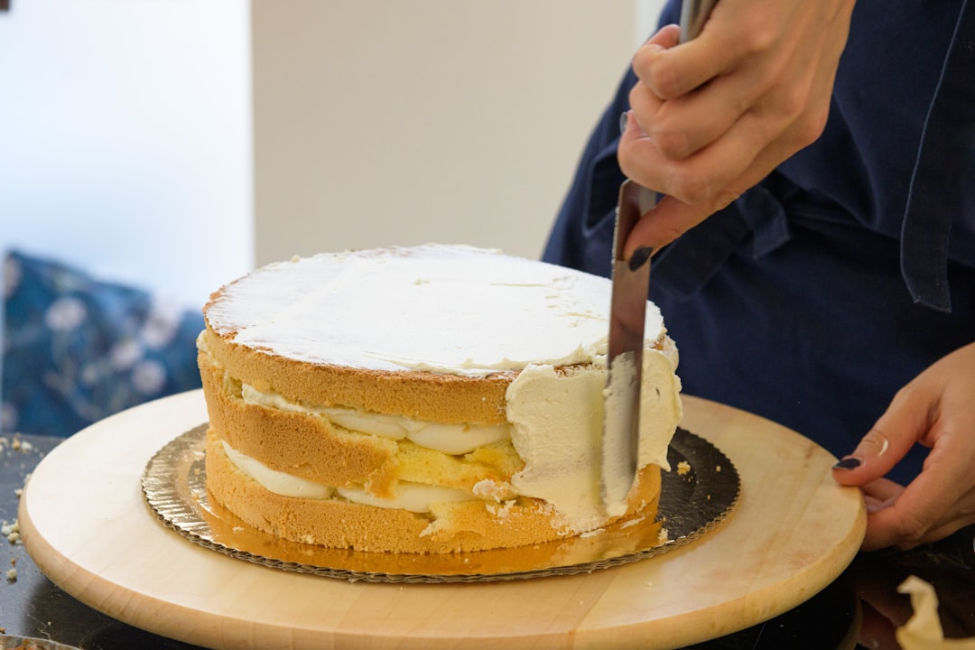 Offset spatula frosting a layer cake