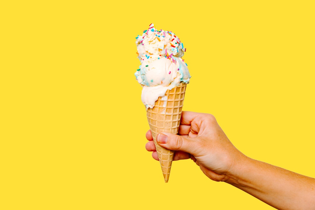 Ice cream topped with rainbow sprinkles and chocolate sauce