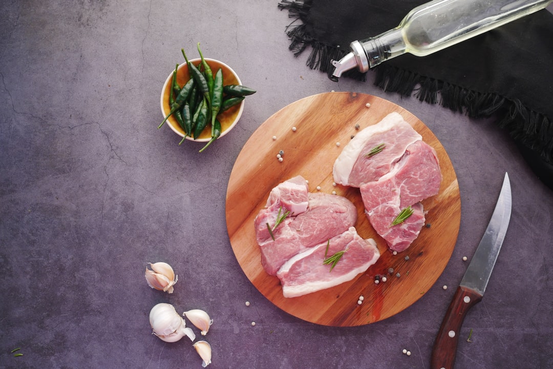 Pork chops searing in a pan on a home stove