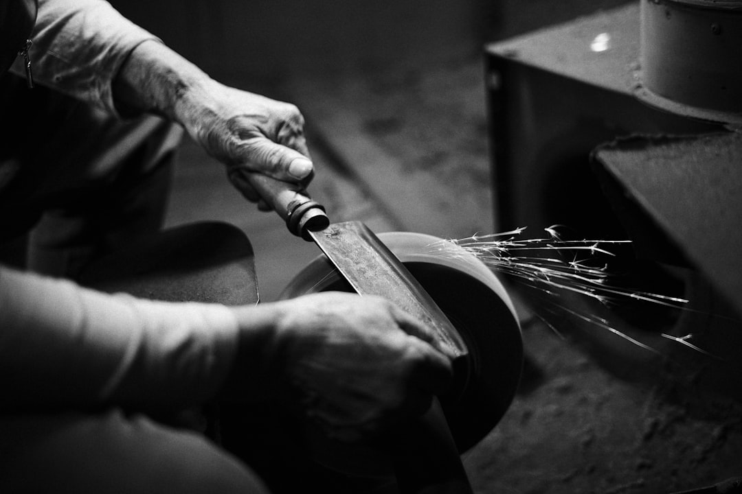 Honing steel rod being used to maintain a kitchen knife