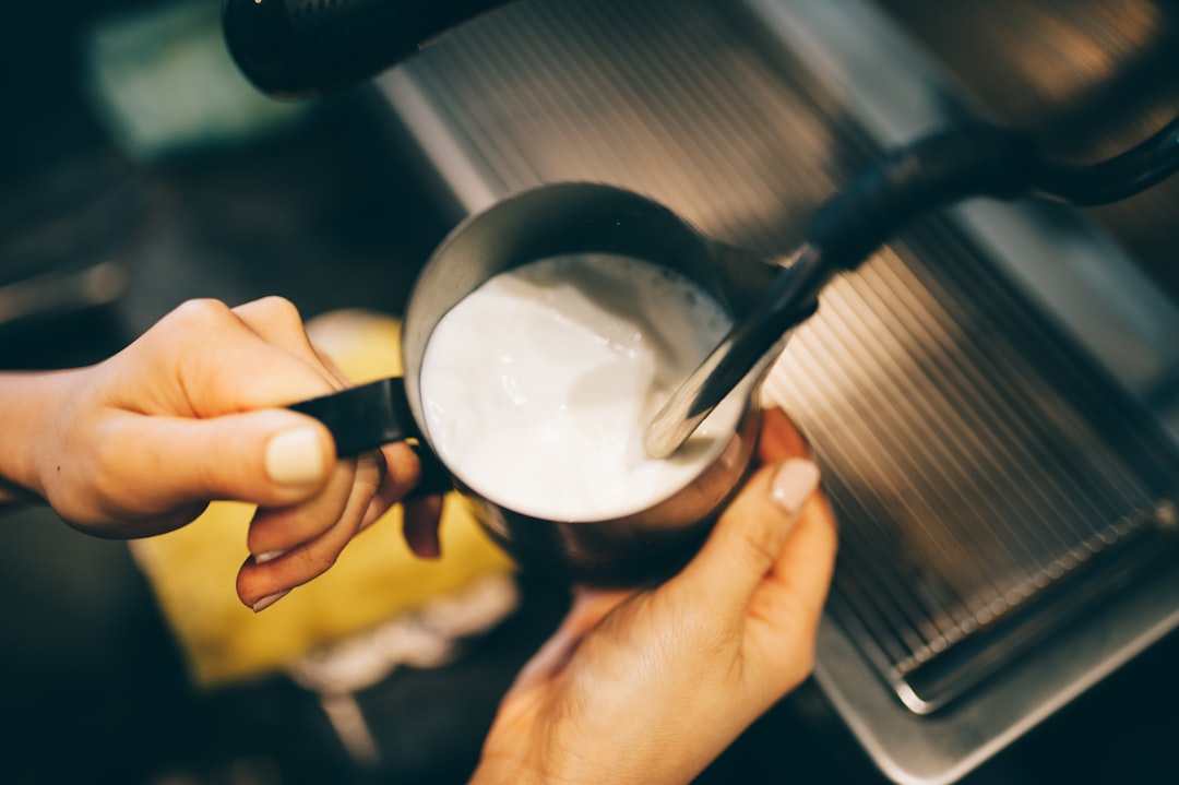 Milk being steamed in frothing pitcher