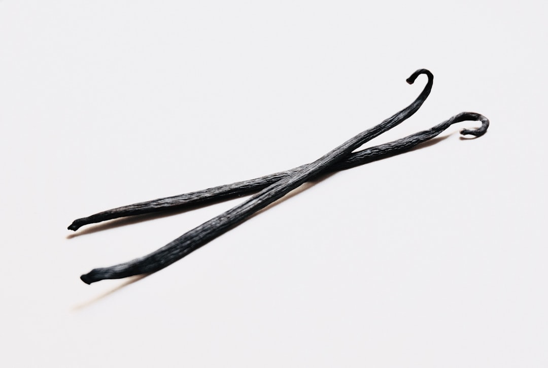 Vanilla beans and extract on a wooden cutting board