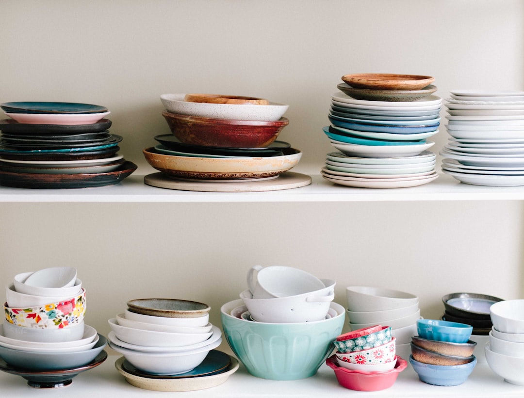 Stacked white dinnerware plates neatly stored in a cabinet