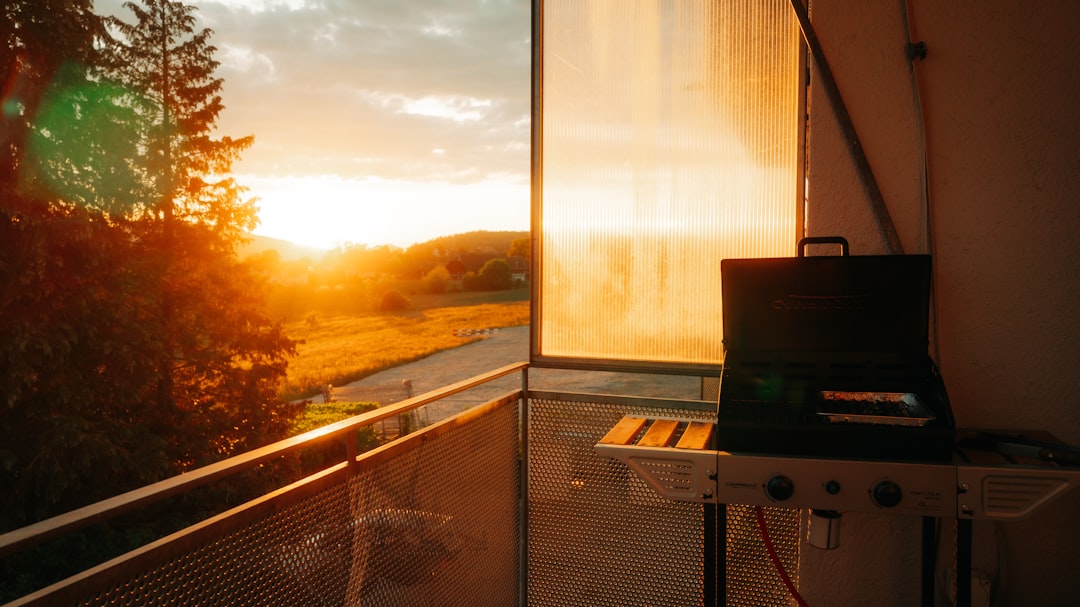 Grill smoking at sunset on a backyard patio