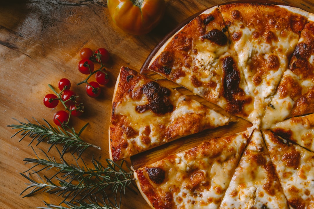 Fresh pizza on a wooden board ready to slice