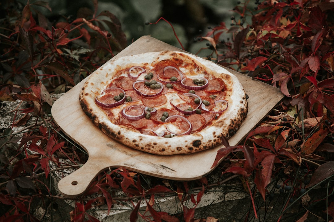 Wooden pizza peel with pizza dough ready for the oven