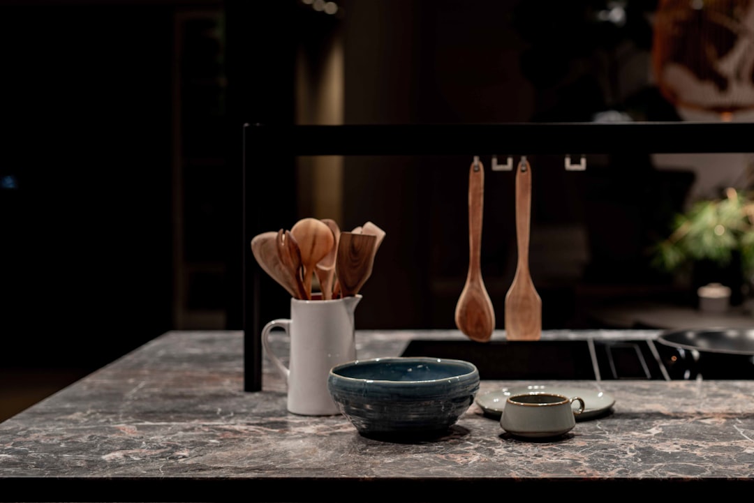 Wooden cooking spoons arranged in a kitchen utensil holder