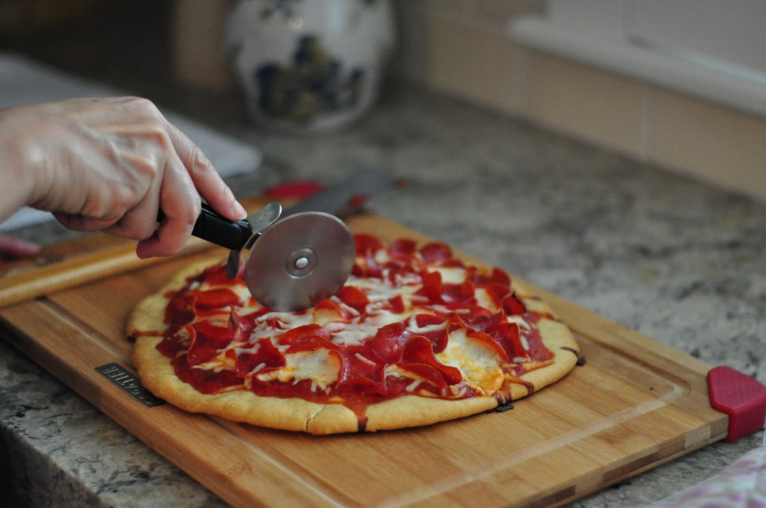 Pizza wheel cutter in action in the kitchen