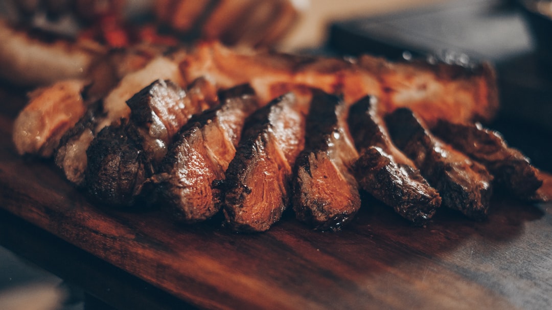Grilled steak resting on a wooden cutting board