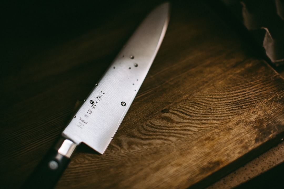 Japanese santoku knife being used to cut vegetables