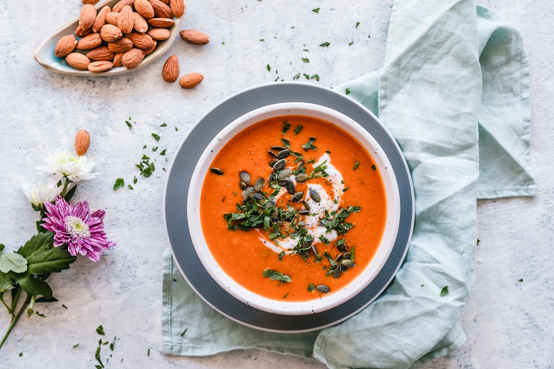 Immersion blender pureeing soup directly in a cooking pot