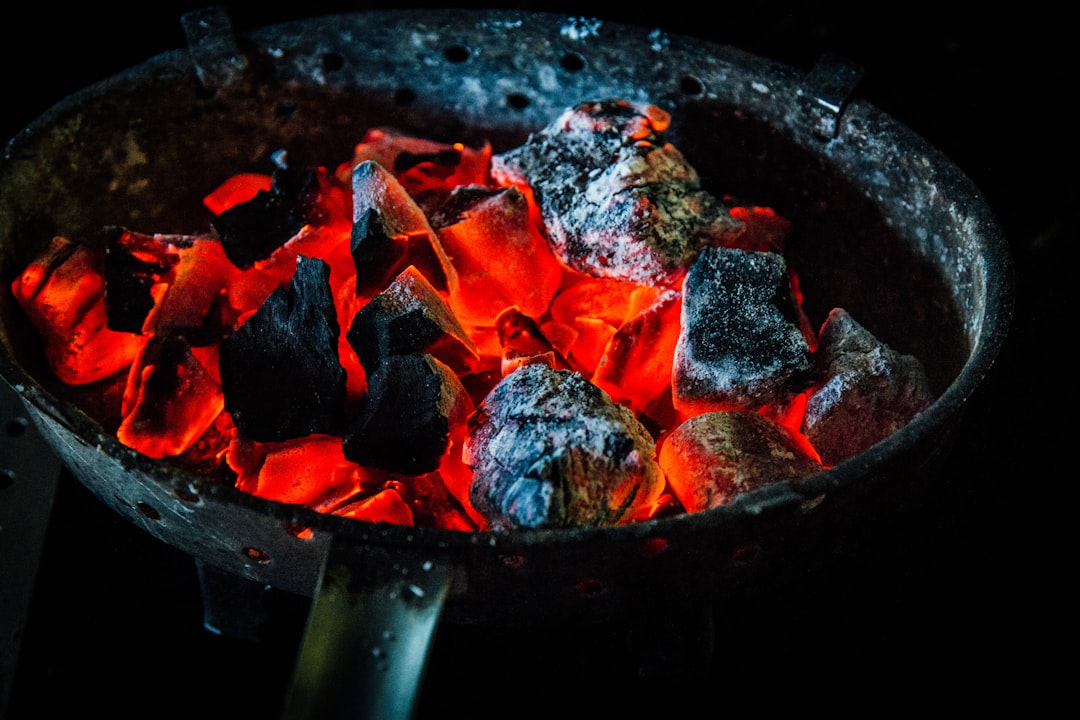 Charcoal chimney starter glowing red with burning coals