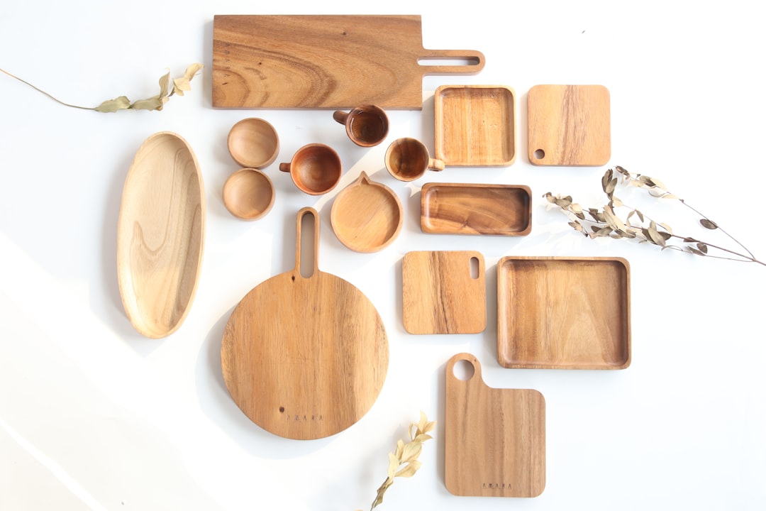 Acacia wood cutting board and stove cover on a kitchen stovetop