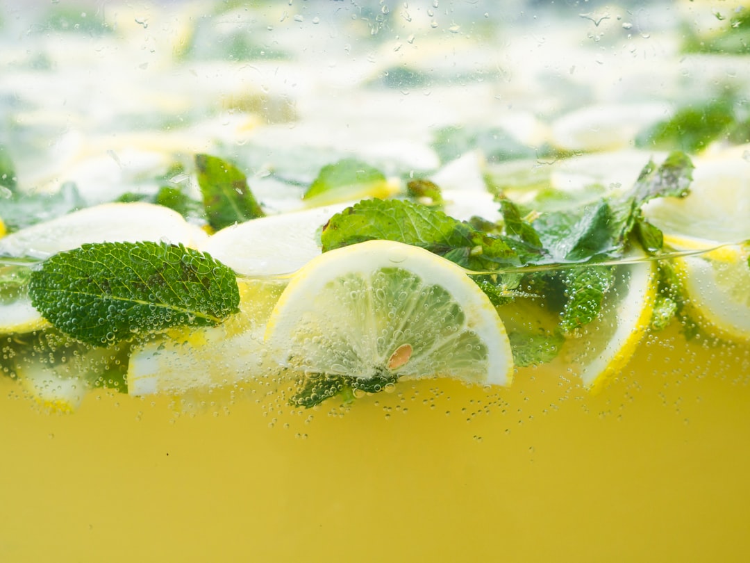 Homemade lemonade in a glass pitcher with ice