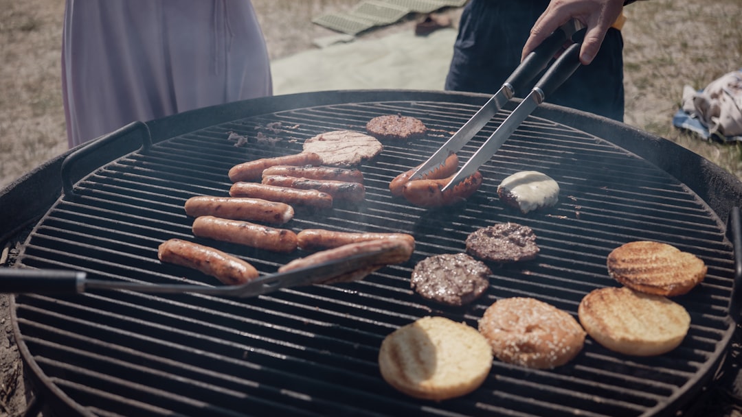 Platter of grilled burgers ready to serve at an outdoor barbecue