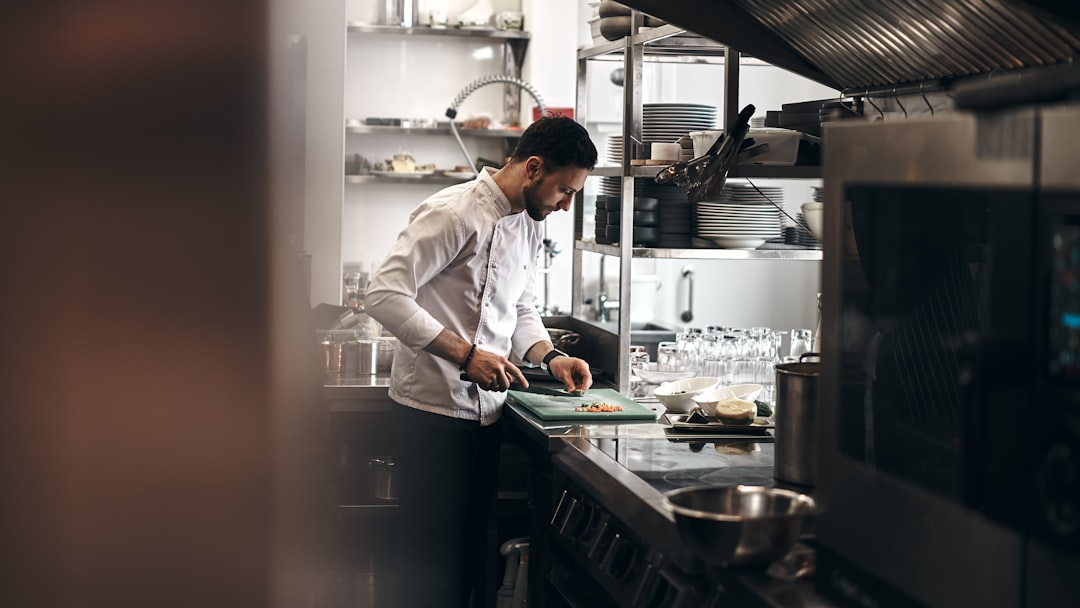 Chef checking food temperature with a digital thermometer in a home kitchen