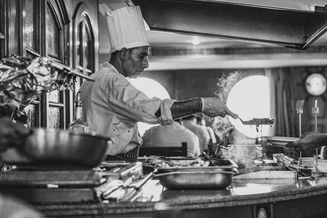 Chef checking temperature of food on grill