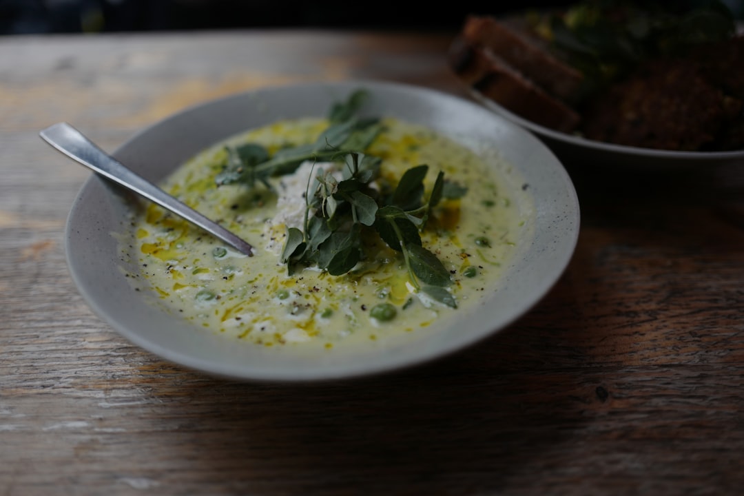 A rustic bowl of butternut squash soup garnished with cream