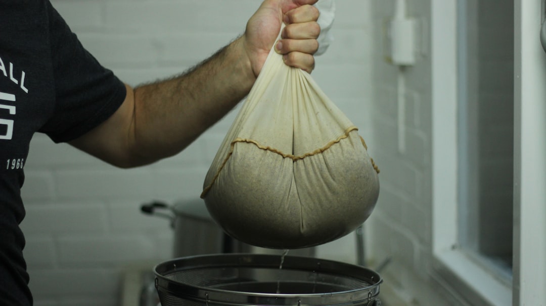 Straining homemade broth through a fine mesh sieve