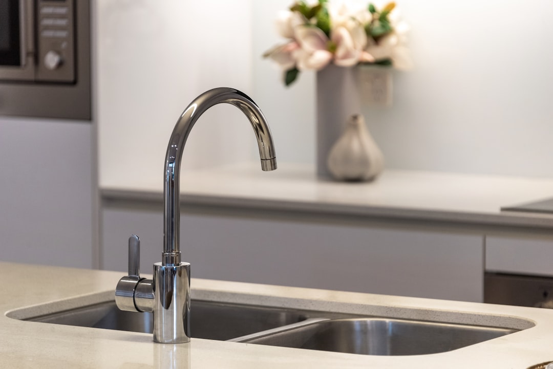 Kitchen sink plumbing pipes under cabinet