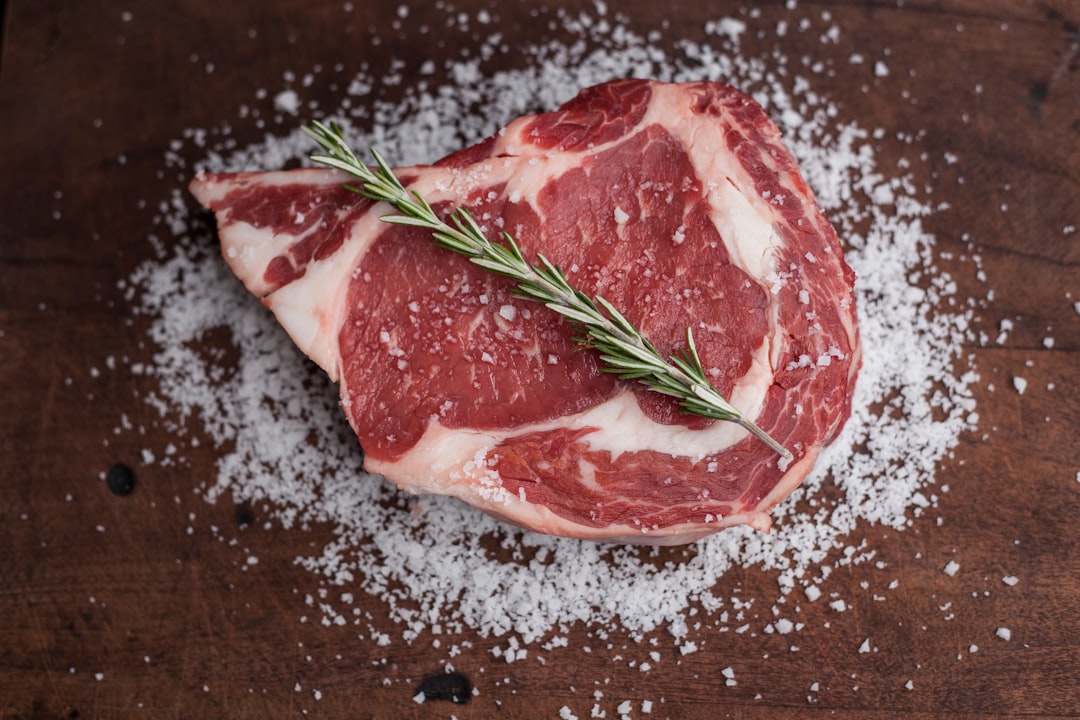 Raw steak with seasoning and spices ready to cook