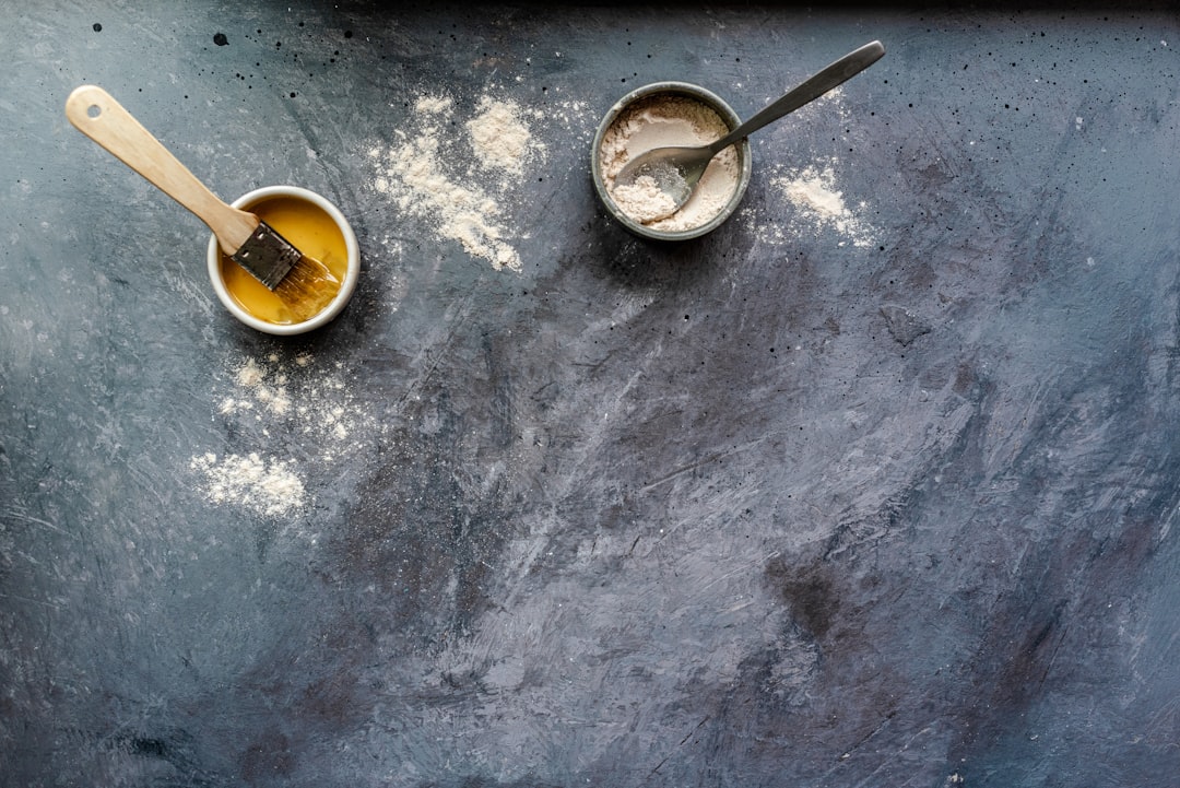 Stainless steel measuring cups and spoons with baking ingredients