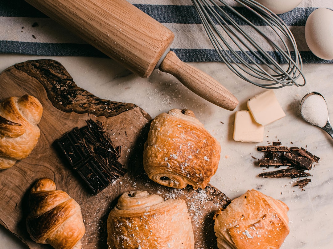 Pastry chef rolling dough with rolling pin