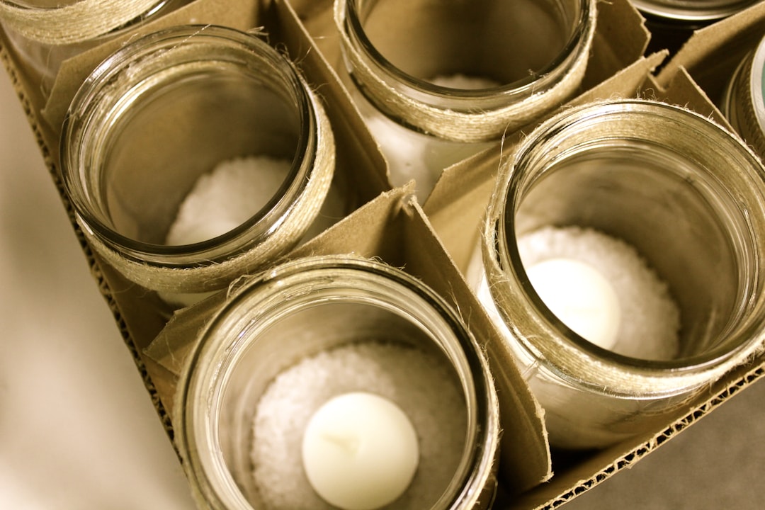 Glass Mason jars lined up on a pantry shelf