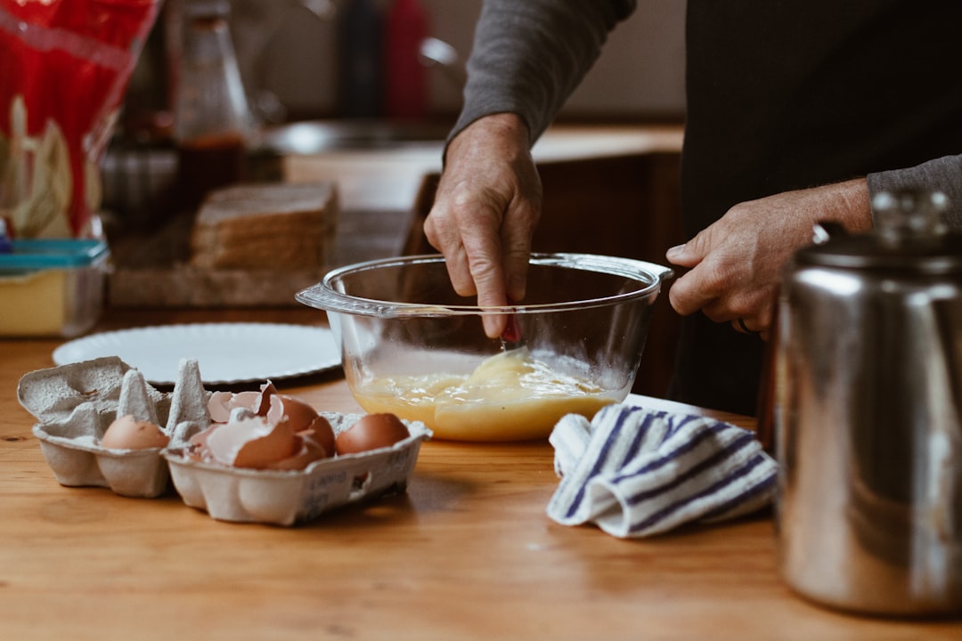 Cake batter being poured into mixing bowl