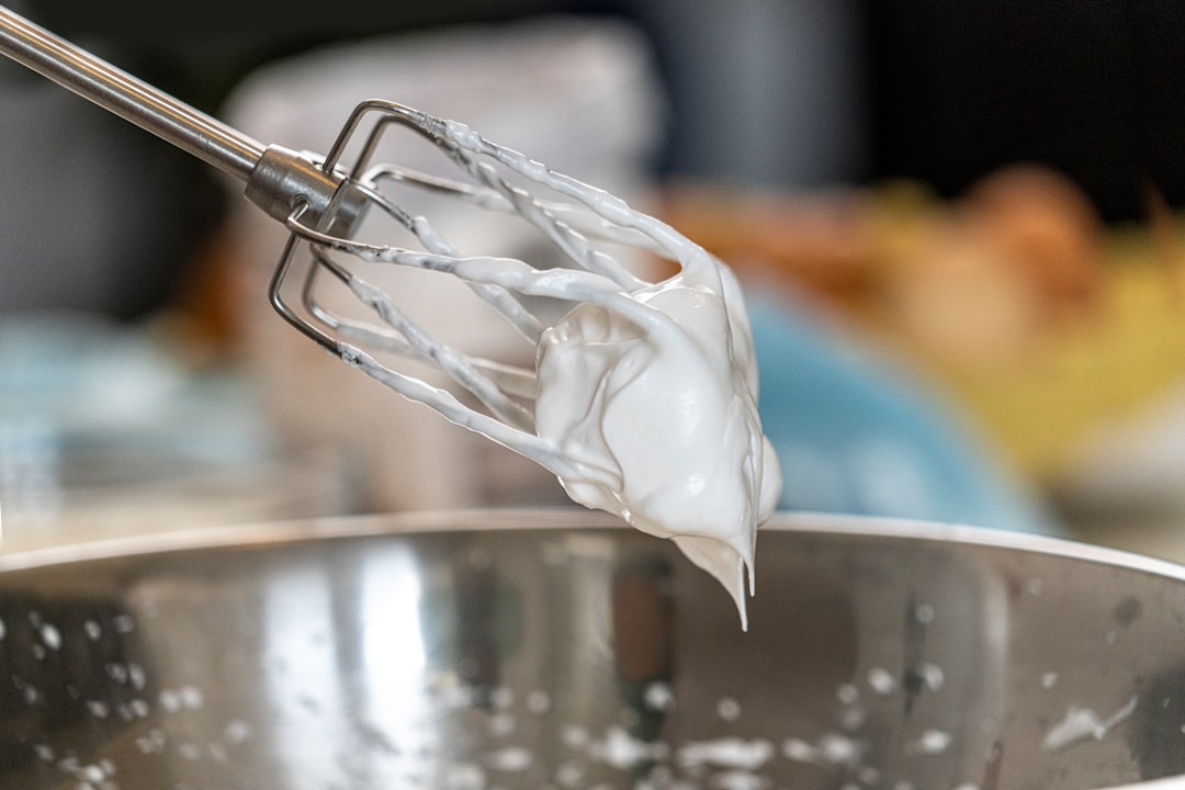 Whipped cream being mixed in a stand mixer
