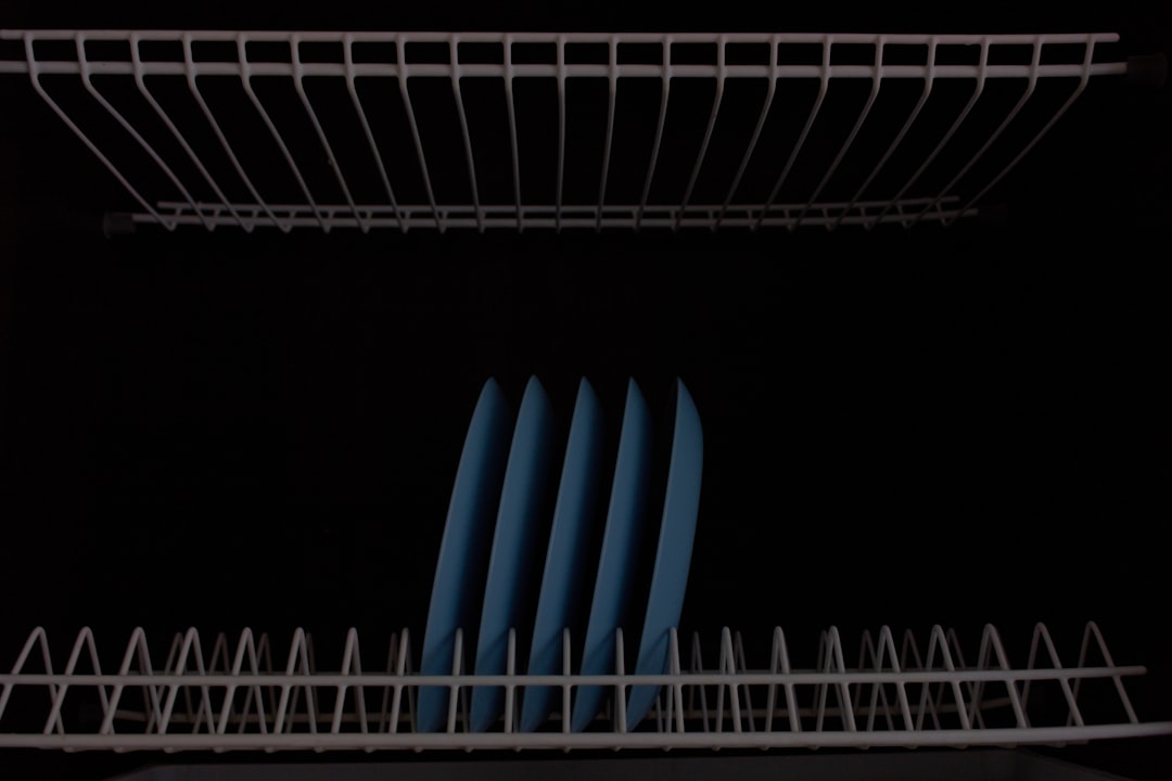 Juicer components disassembled on drying rack by sink