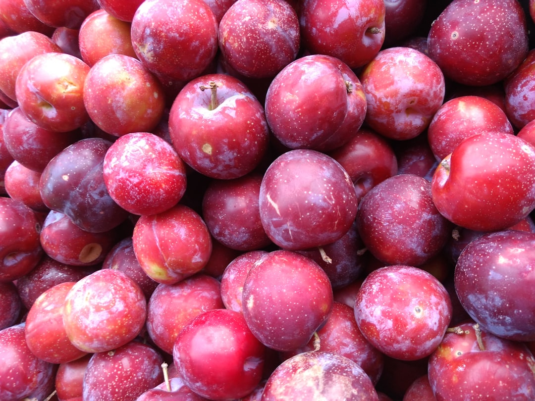 Fresh plums and nectarines arranged on a wooden surface