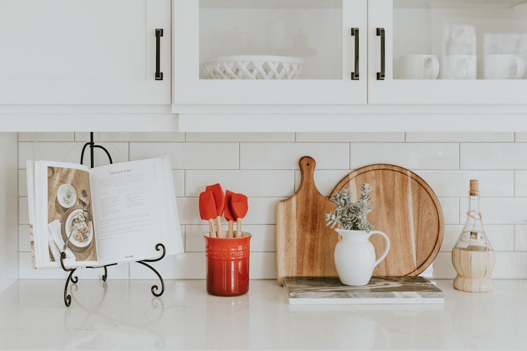 Tiered cabinet shelf organizers maximizing vertical pantry space