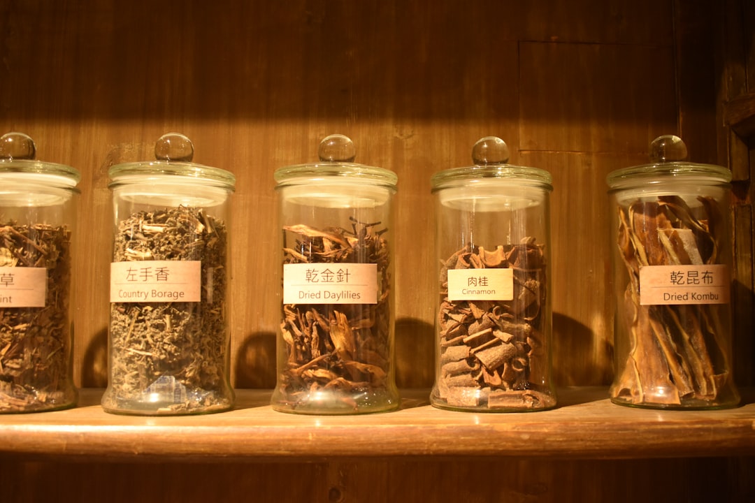 Uniform seasoning jars arranged on a wooden shelf