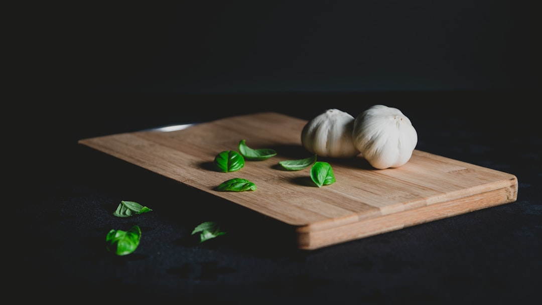 Chopping onions and garlic on a wooden cutting board
